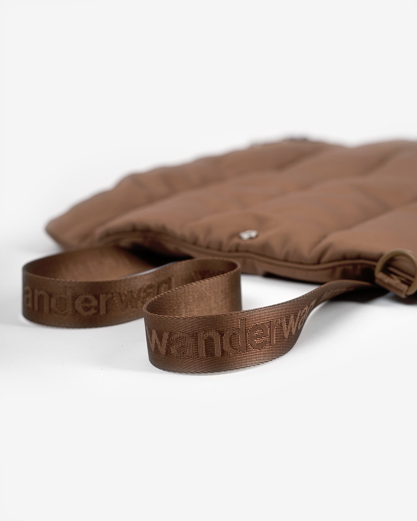 close up of the tote bed shoulder strap on a white backdrop
