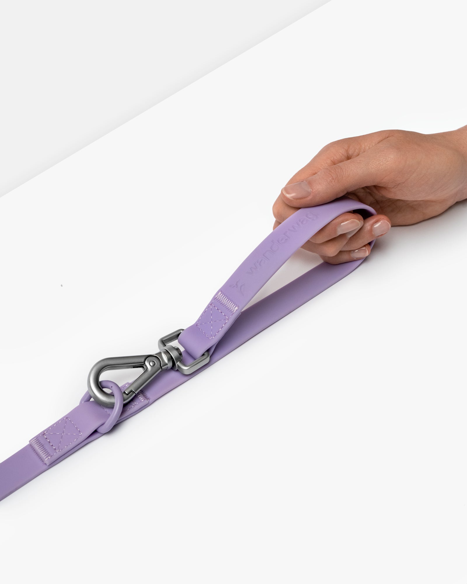 wanderwag leash on a white backdrop with a hand holding it