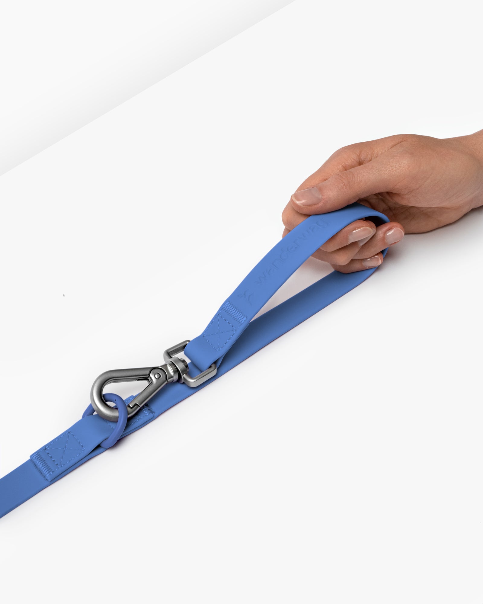 wanderwag leash on a white backdrop with a hand holding it