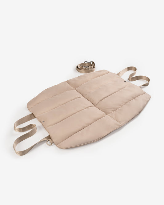 dog bed laying on a white studio backdrop